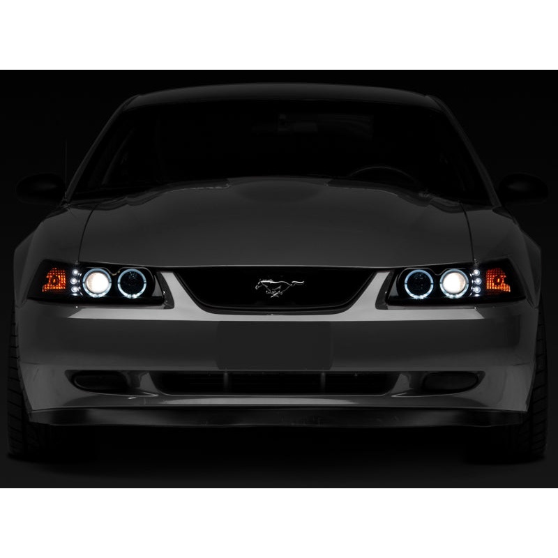 Raxiom 99-04 Ford Mustang Dual LED Halo Projector Headlights- Black Housing (Smoked Lens)